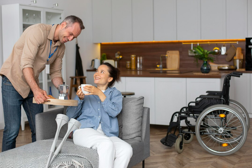 Counselor and a senior man talking over tea at a table